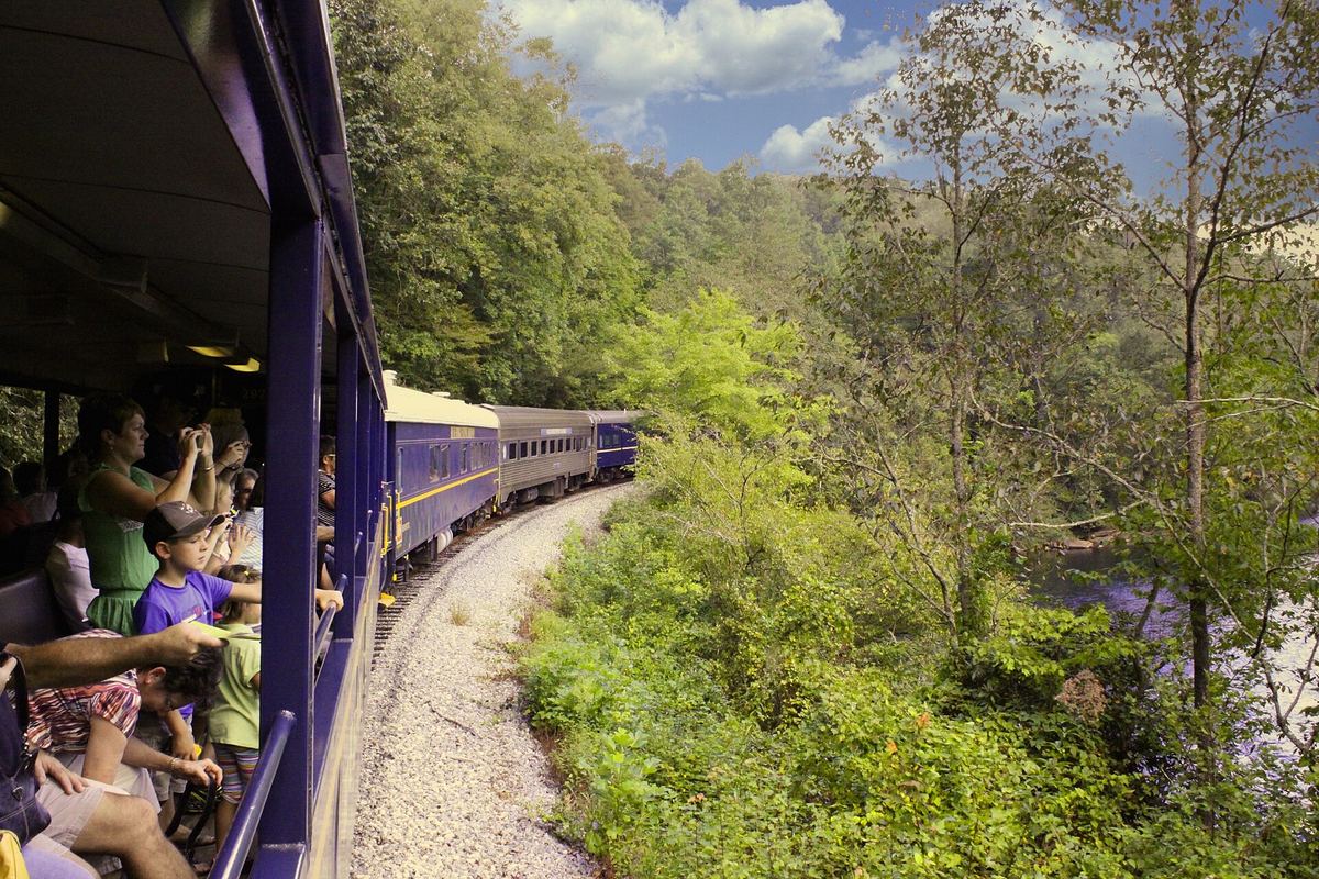 Passengers looking out from open-air cars of the Blue Ridge Scenic Railway