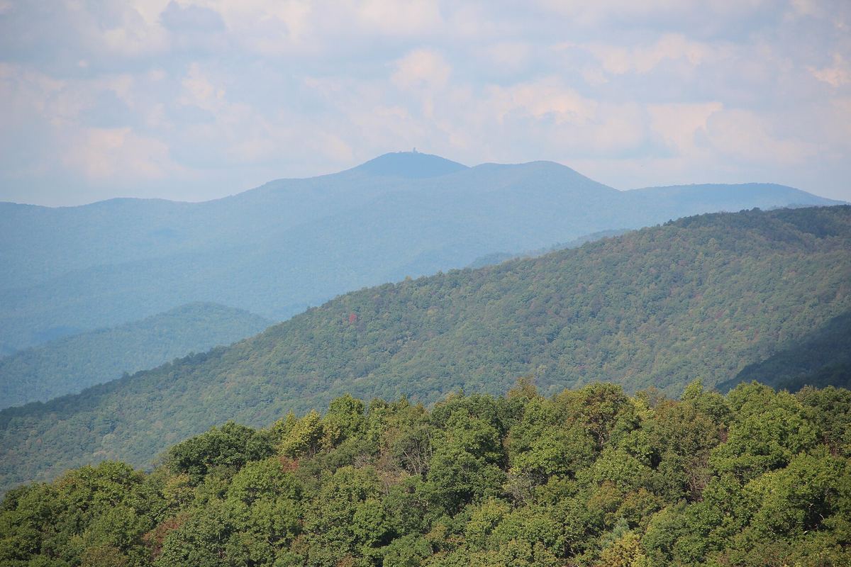 Layered blue-green mountain ridges with Brasstown Bald rising in the distance